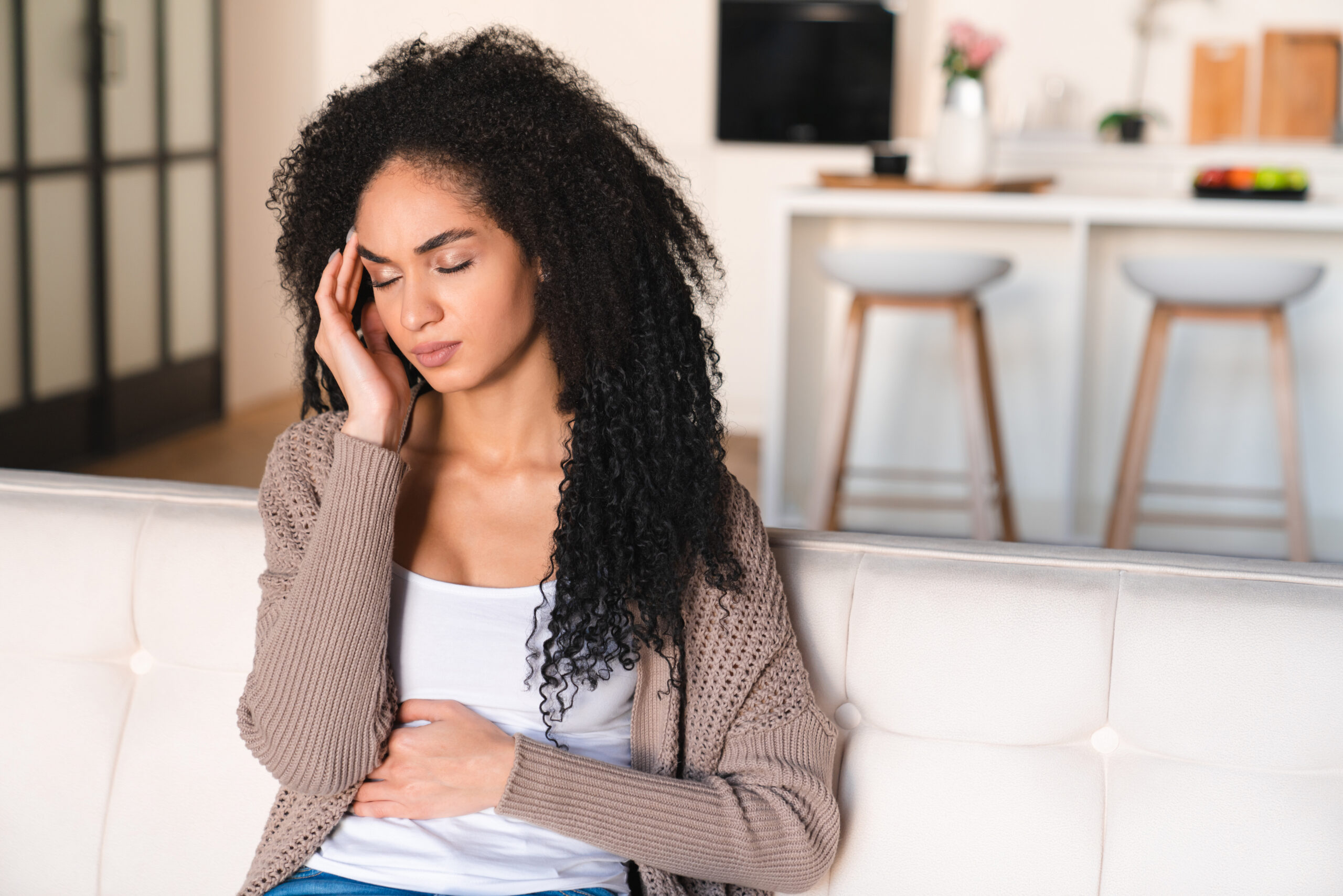 Young woman having stomach ache from leaky gut syndrome.